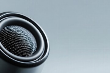 close up of a small audio speaker with a metal grill