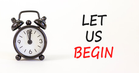 Let us begin symbol. Concept words Let us begin on beautiful white paper. Beautiful white background. Black alarm clock. Business motivational let us begin concept. Copy space.