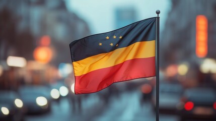 Flag of the Federal Republic of Germany waving on pole, blurred evening city street on background