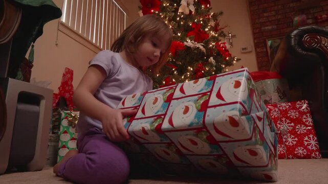 Little Girl Unwrapping Doll For Christmas