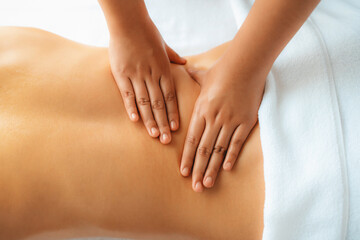 Closeup woman customer enjoying relaxing anti-stress spa massage and pampering with beauty skin...