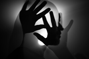 silhouette of a person and his hands in multiple exposure way