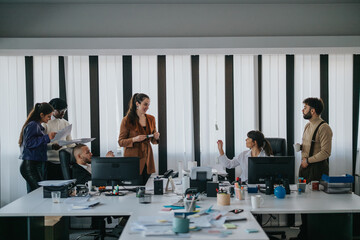 Group of office professionals discussing ideas, collaborating on projects, and managing daily tasks in a busy workspace environment, featuring desks, computers, documents, and teamwork.