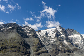 The Grossglockner mountain range with snow on the peaks and a blue sky