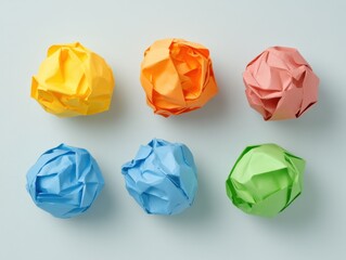 Naklejka premium crumpled colorful paper balls on a light blue background