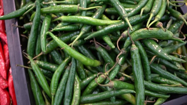 Pile green chilies in basket