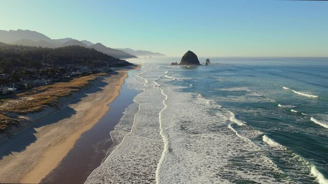 Aerial Flight Toward Haystack Rock and Cannon Beach Town on Oregon Coast