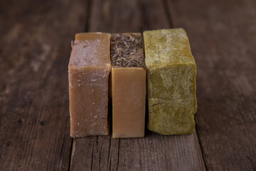 Bar soap of different colors on old wooden background