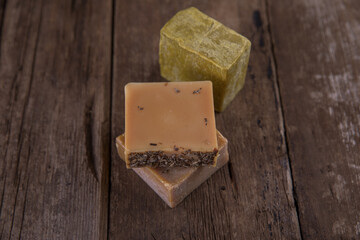 Bar soap of different colors on old wooden background