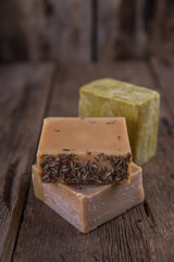 Bar soap of different colors on old wooden background
