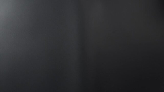 A classic film clapperboard or film slate being held and hit against a dark background. Symbolizes filmmaking video production movie filming and creative storytelling in the entertainment industry.