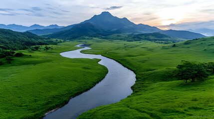 Fototapeta na wymiar Serene river meanders through lush valley, mountain backdrop, sunset