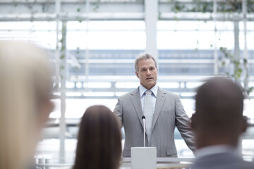 Podium, office and business man with audience for presentation, conference and convention....