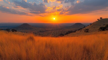 Sunset over African savanna with hills.