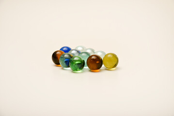 Colorful glass balls on a white background. The decor is made of multicolored glass.
