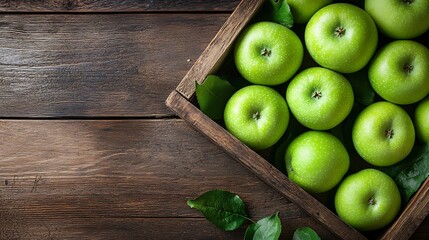 Green apples in a wooden box on a dark wooden background. Top view.