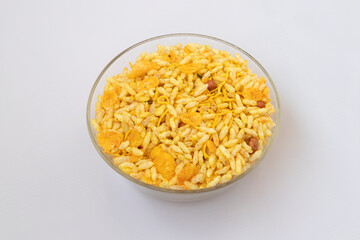Indian snack Sev-Mamara chivda in a glass bowl Isolated on white background