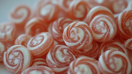 A delightful close-up of swirl-patterned candies, cascading in red and white hues, enticing and sweet.