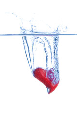 Red heart falls with a splash into  water. Valentines day card