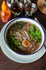 Pho Bo – Classic Vietnamese beef noodle soup with fragrant broth, rice noodles, thinly sliced beef, fresh herbs, lime, and chili. Authentic Asian flavors in a traditional bowl