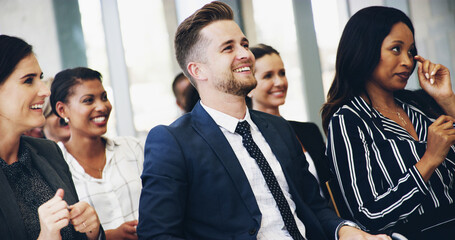 Obraz premium Man, listening and happy in audience, convention and excited for company goals with cheers. Business people, crowd and together with diversity, success or smile for announcement at insurance agency