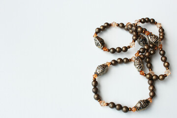 Horizontal background with copy space showcasing a brown beaded woman's vintage necklace. Personal fashion accessory, bijouterie, handmade jewelry, beads.
