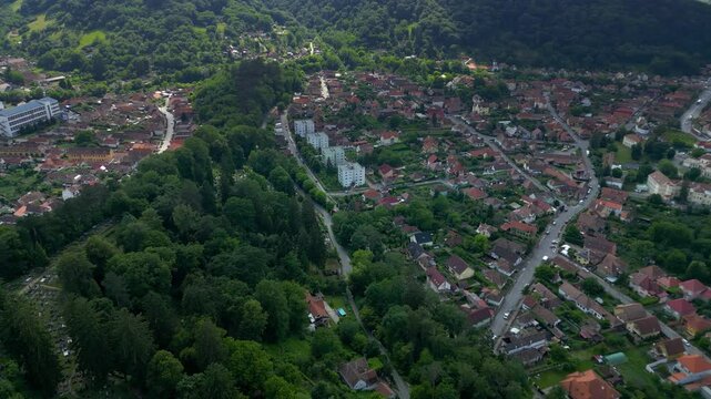 Historic centre of Sighisoara, Romania, aerial view. It is a popular tourist destination for its well-preserved old town, which is listed by UNESCO, World Heritage Site. Drone panning left, circling.