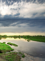 Cloudy sky with a river in the foreground