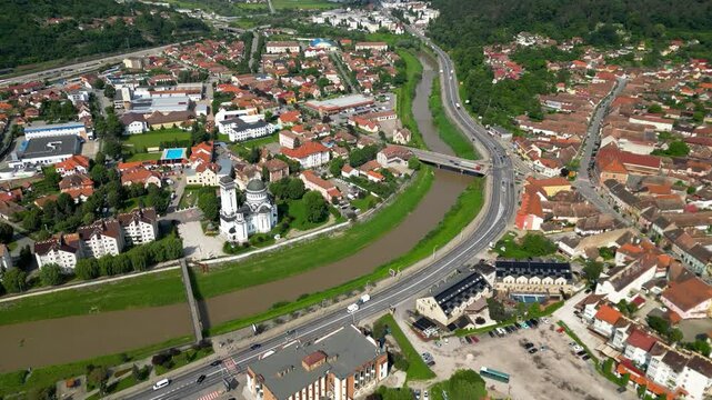  Aerial perspective of Tarnava Mare River and part of Sighisoara city. Famous travel destination. Drone going forward. Typically, Romanian village.