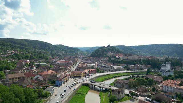 Sighisoara city, Romania. Church in top of the hill. Sighisoara Fortress. Panoramic view of all region. Tarnava Mare River. Famous travel destination. Drone ascending.