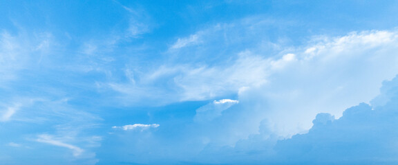 A beautiful and inviting blue sky with fluffy white clouds, representing the essence of summer.
