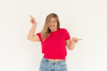 Image of beautiful woman pointing fingers left and right, making decision, showing two variants choices, standing over white background