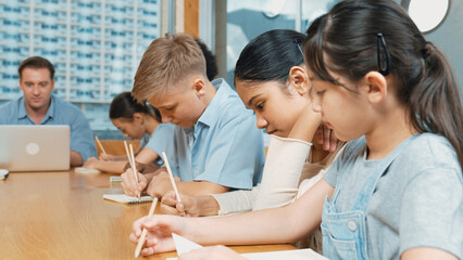Caucasian teacher and multicultural students clapping hand or putting the hand in the air together...