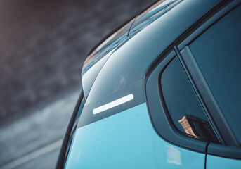 Close up of a C-pillar trim on new hatchback. Side view of car rear side part at dawn. 