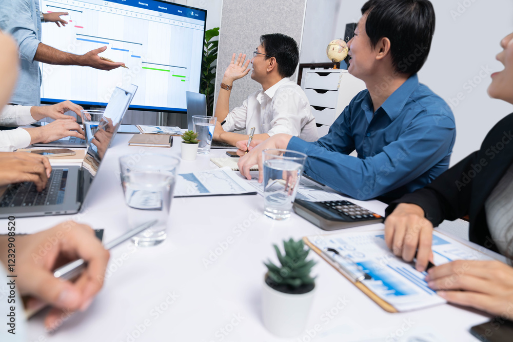 Leinwandbilder Project manager communicate and collaborate with team using project management software display on monitor, tracking progress of project task and making schedule plan at meeting table. Prudent