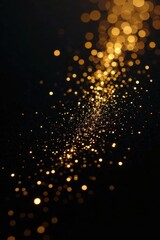 Fototapeta premium Scattered gold glitter, fine texture on black, backdrop, gold glitter