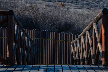 Wooden Fence and Plank Wall in Sunlit Harmony