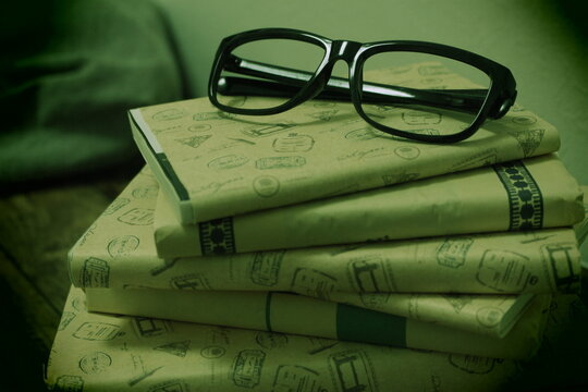glasses and book in darkness
