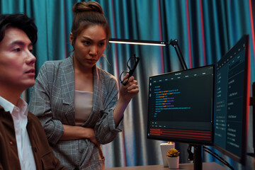 IT developers discussing with point to intelligent website development coder system running data...