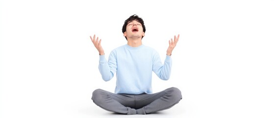 man meditating in a light blue shirt and gray pants