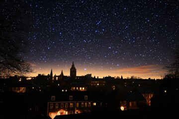 Obraz premium Night sky filled with stars over a city skyline with illuminated buildings and towers