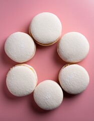 Obraz premium Generated image Alfajores on a solid pastel pink background, arranged in a circle 