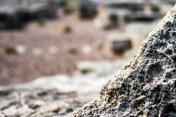Ancient stones close-up with blurred background. Zoomed-in view of ancient stones of old city.