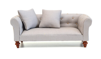 Modern grey fabric sofa with pillows isolated on white background. Front view. Strict style furniture