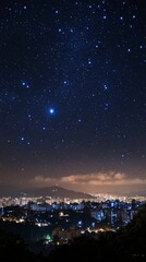 Obraz premium City skyline under a starry night sky with visible constellations and distant hills