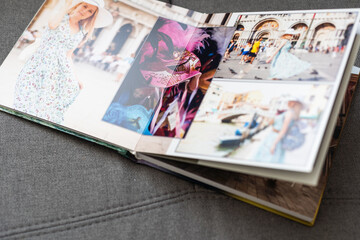 Family photos archive saved in brightly designed photo book; bright summer memories placed in the photobook