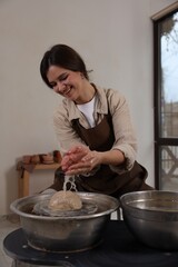 Hobby and craft. Smiling woman making pottery indoors