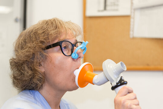 Spirometry test conducted by a female patient at a pneumology department