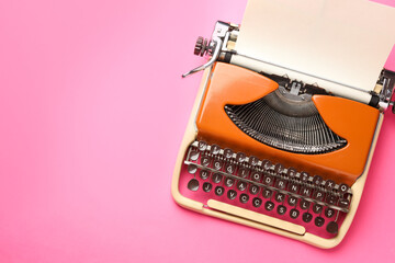 Vintage typewriter with sheet of paper on pink background, top view. Space for text