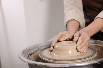 Hobby and craft. Woman making pottery indoors, closeup. Space for text